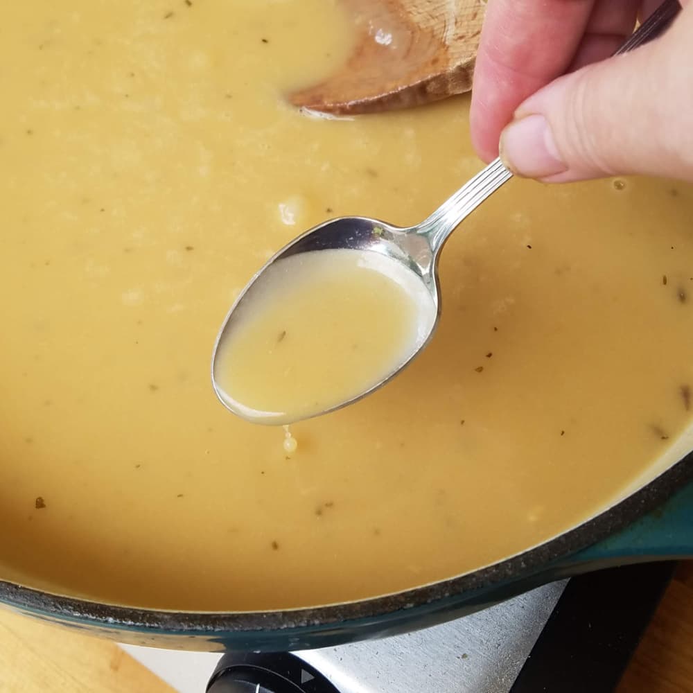 Chicken sauce dripping from spoon. 