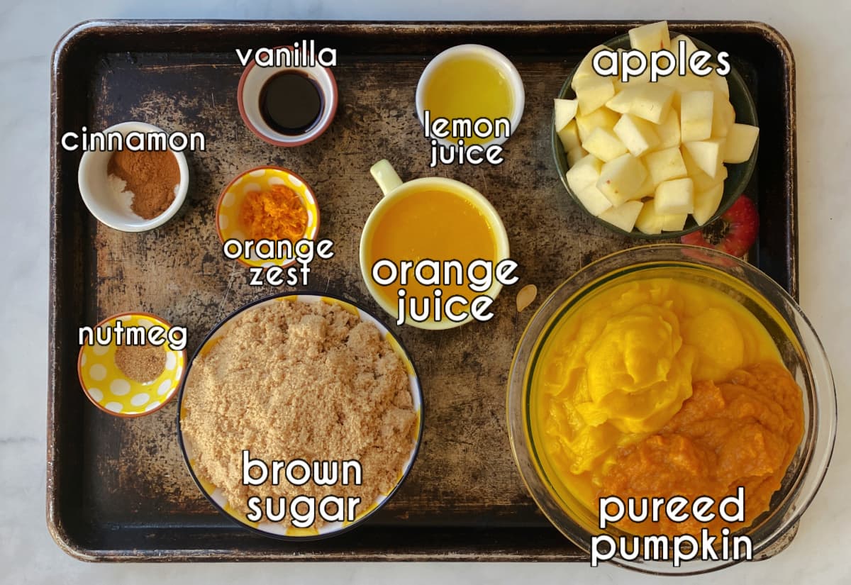 Pumpkin butter ingredients, labeled: pureed pumpkin, apples, orange juice, brown sugar, zest, lemon juice, vanilla, cinnamon, nutmeg.