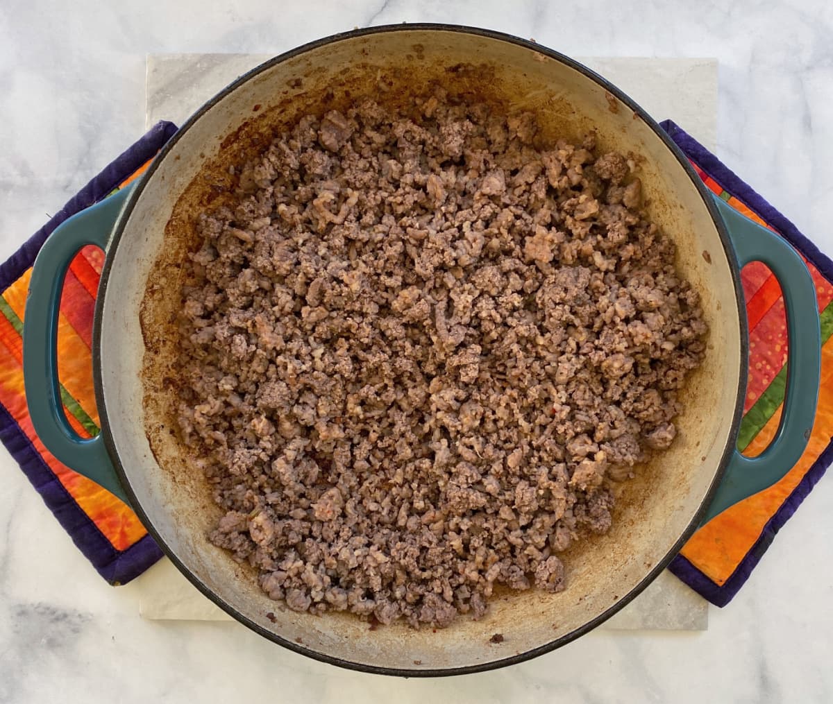 Ground beef browning in large enameled cast iron skillet. 
