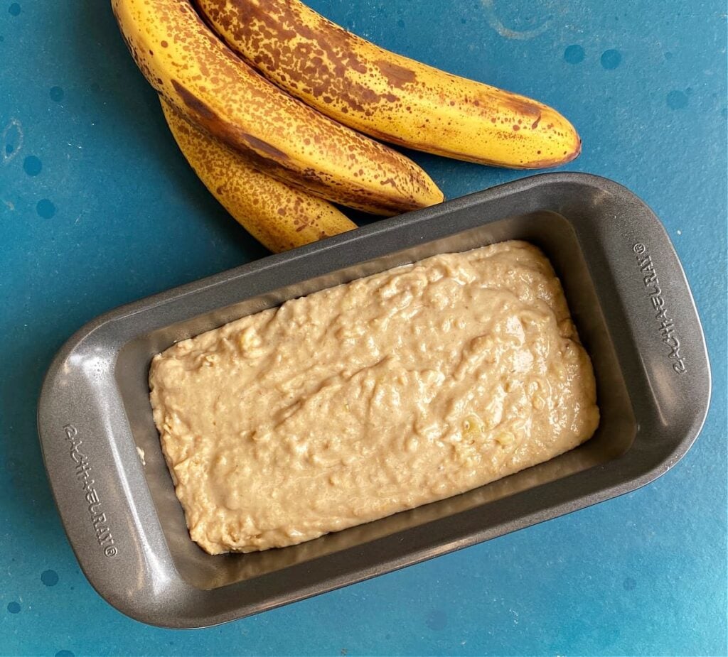 Banana bread batter in loaf pan, ready to bake.