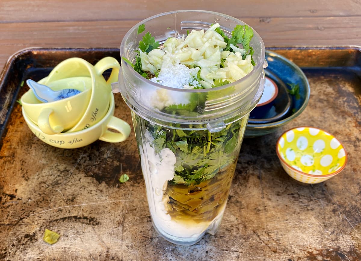 Recipe ingredients in a tall blender cup, unmixed.