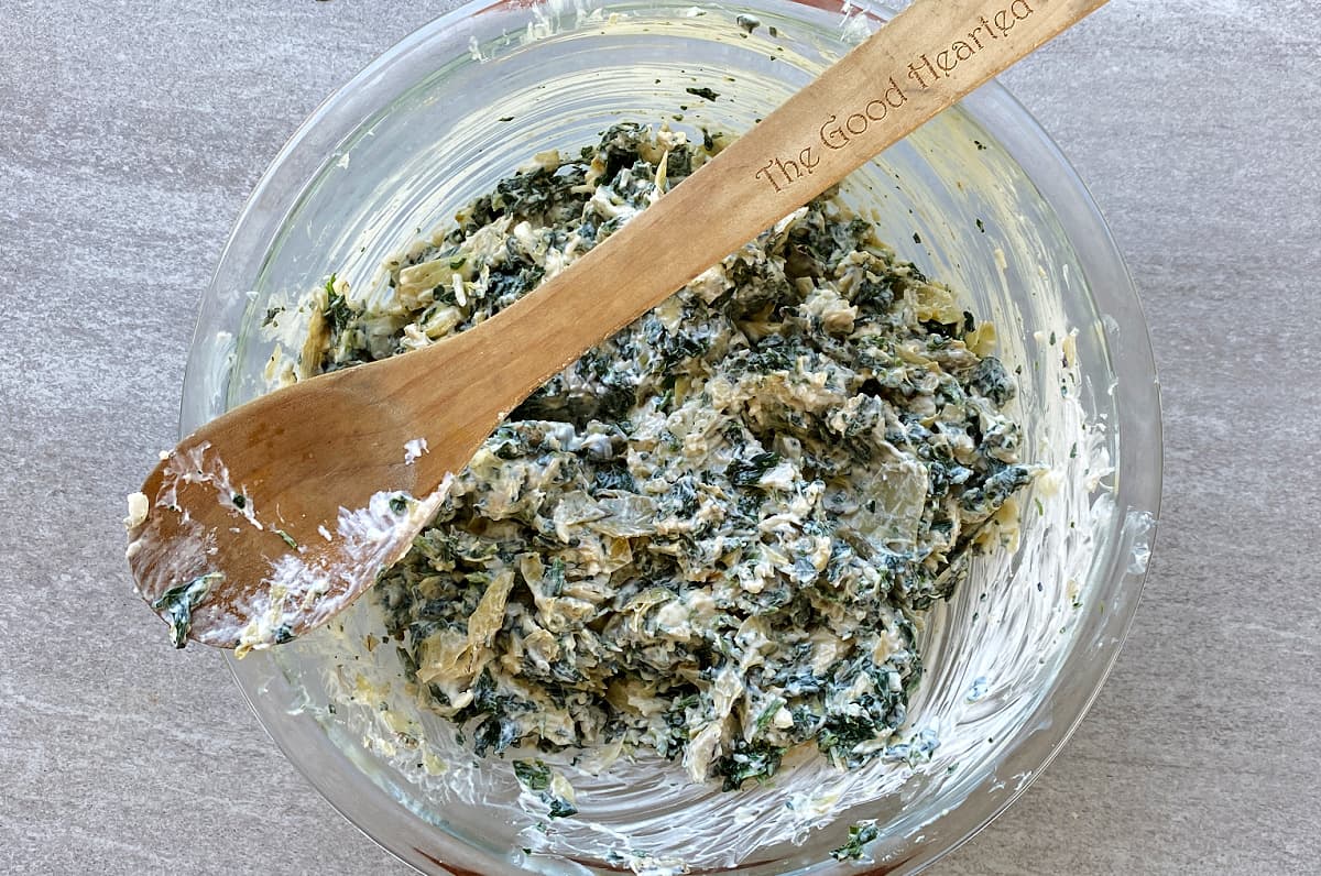 Spinach dip mixed in bowl.