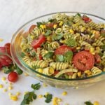 Prepared pasta salad in a glass serving bowl, ready to serve.