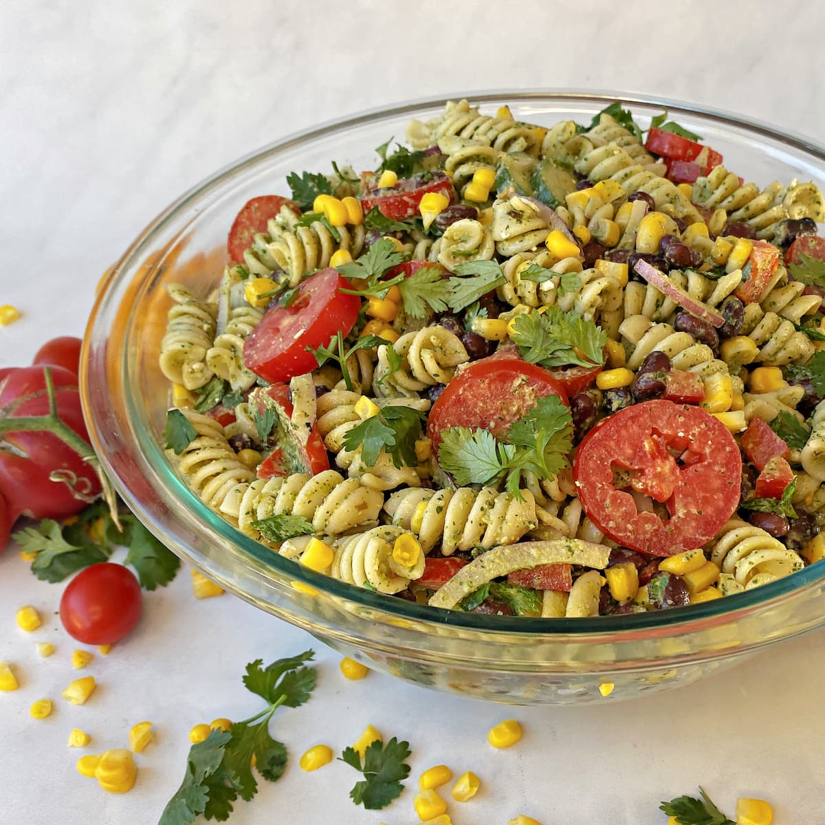 Prepared pasta salad in a glass serving bowl, ready to serve. 