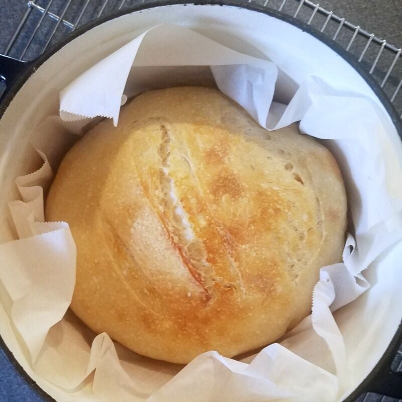 Baked bread in parchment, in Dutch oven.