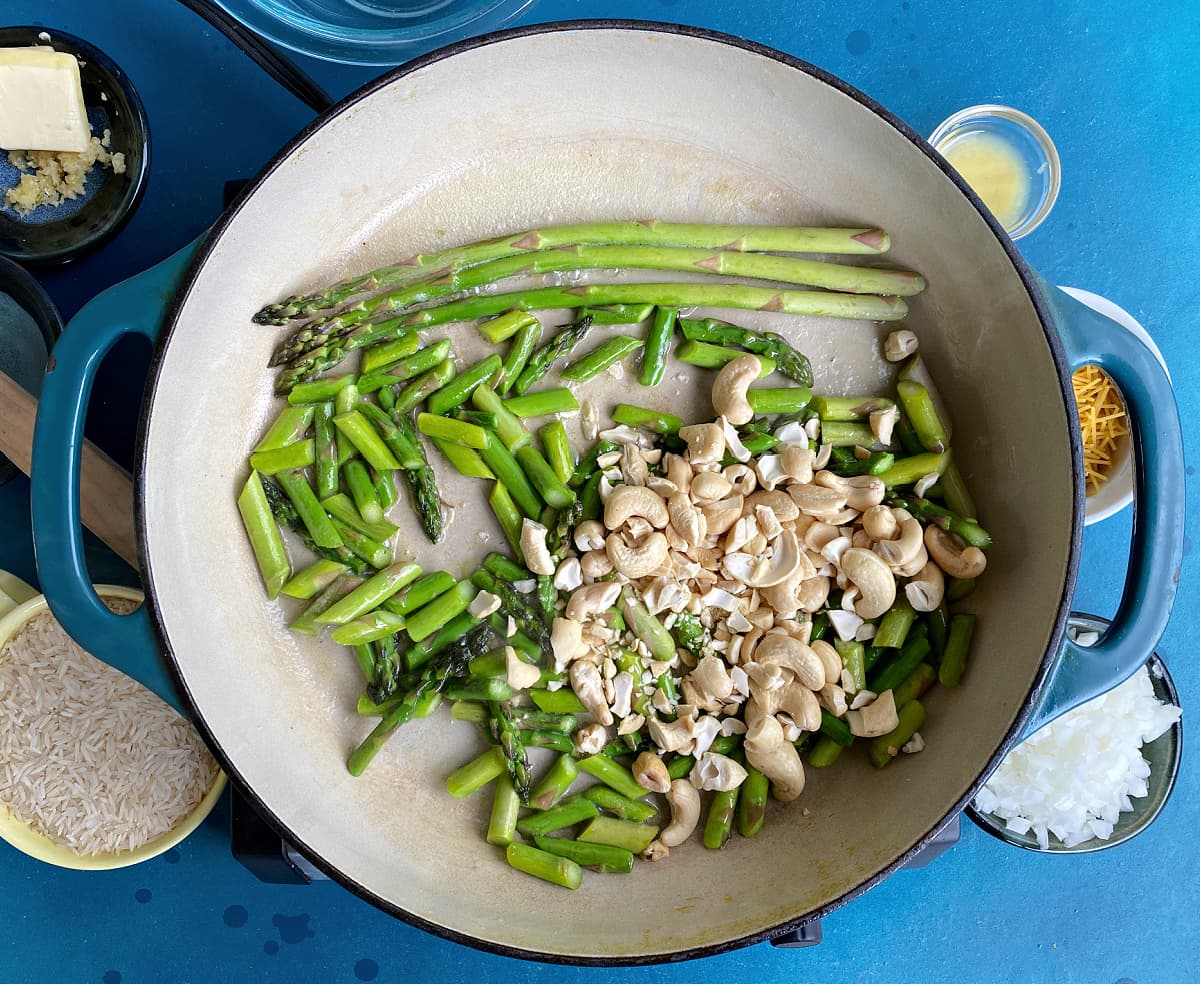 cashews and cut asparagus in large enameled skillet. 