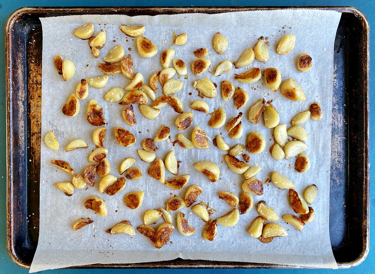 garlic roasted on a baking tray, over 100 cloves. 