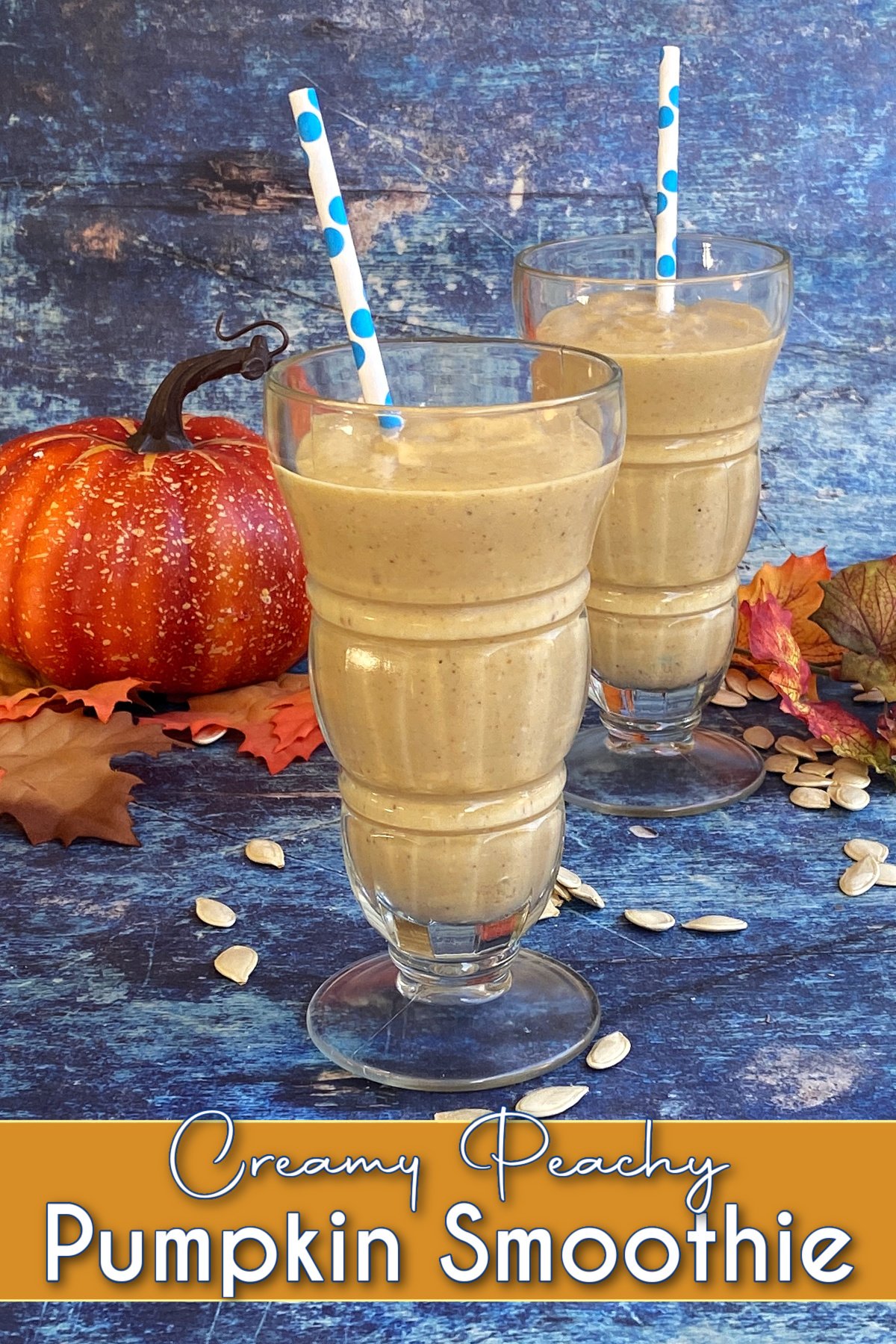 Pumpkin smoothie recipe, whipped up in old-fashioned soda glasses. Pin text reads Creamy Peachy Pumpkin Smoothie. 
