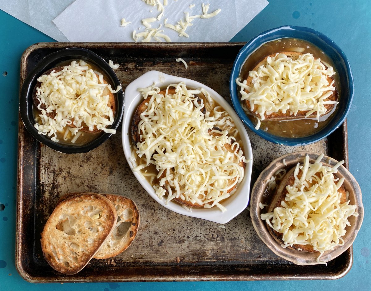 Cheese sprinkled on french bread croutons for French Onion Soup
