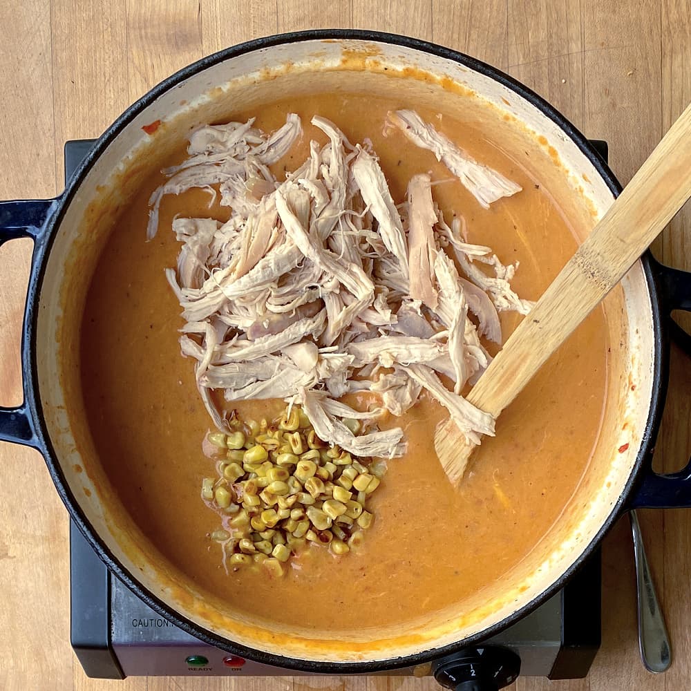 Add chicken and corn to enchilada soup.