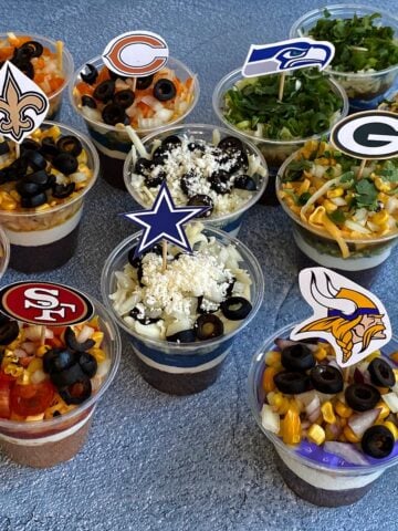 Individual 7-layer dips, made in 7 NFL team colors, including the Cowboys, 49ers, Vikings, Packers, Bears, Seahawks, and Saints.