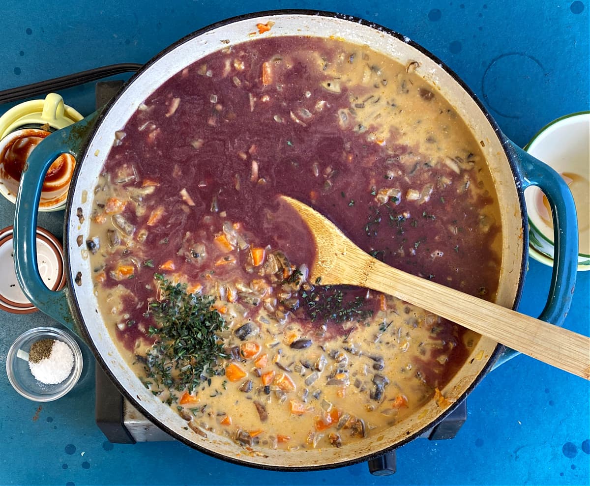 Adding red wine and herbs to Shepherd's pie.
