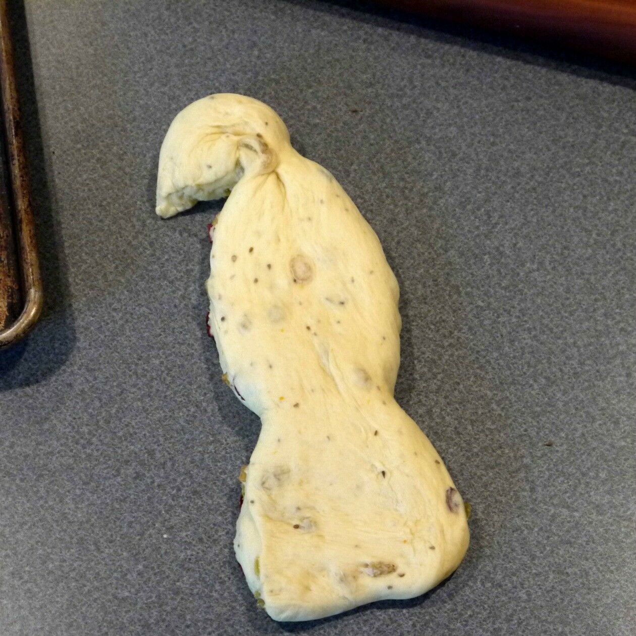 One rectangle of bread dough, shaped into a bird body and head. 