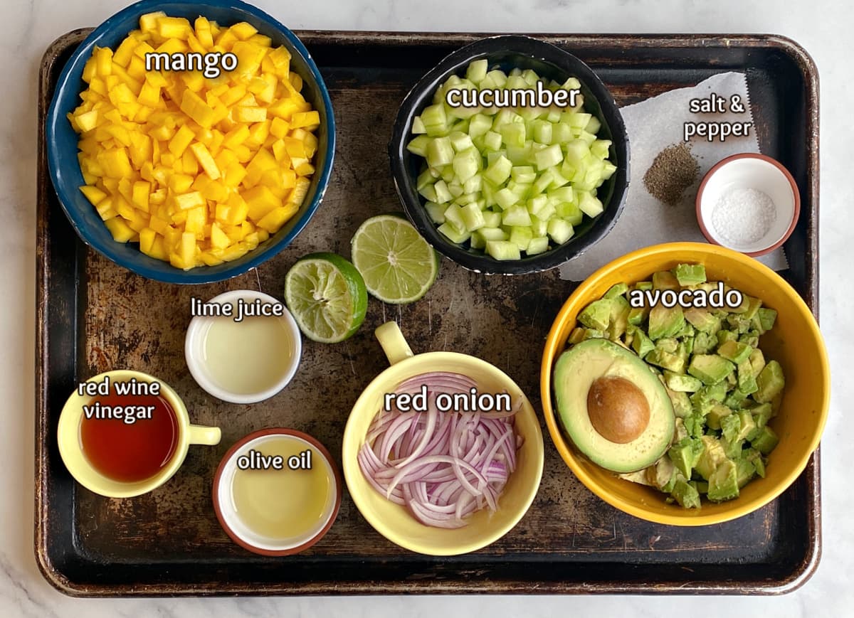 Mango salad ingredients displayed on on old baking tray.