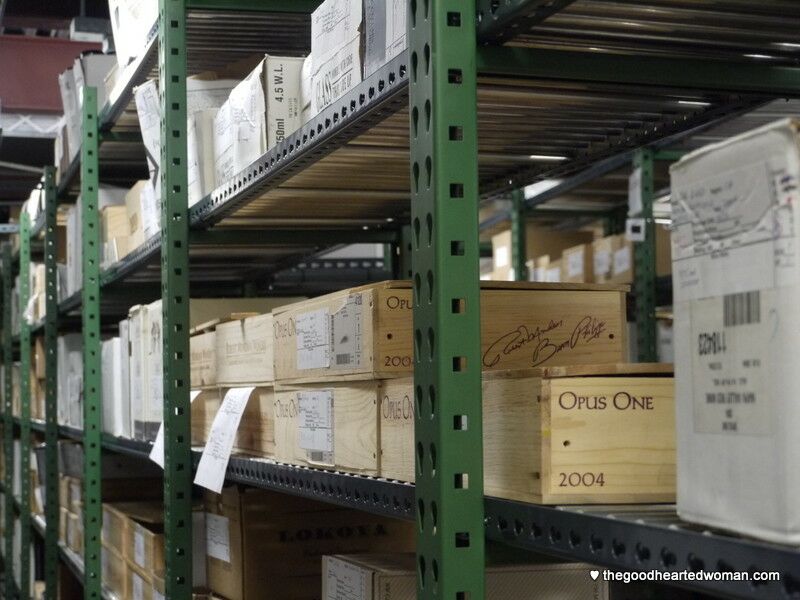 Wine boxes on shelves in back room. 