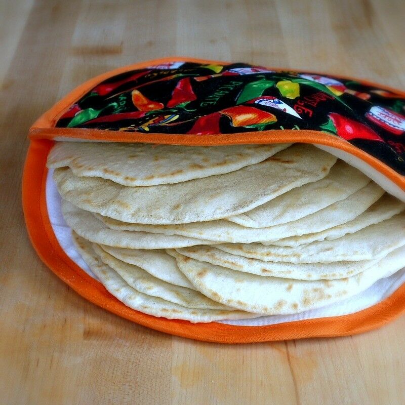 Flour tortillas in a tortilla warmer. 