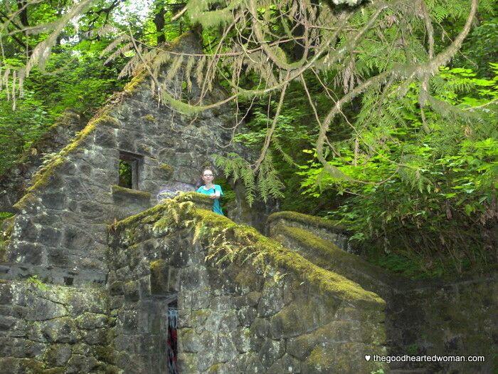 Emmy, posing on moss-covered staircase at Forest Park landmark. 