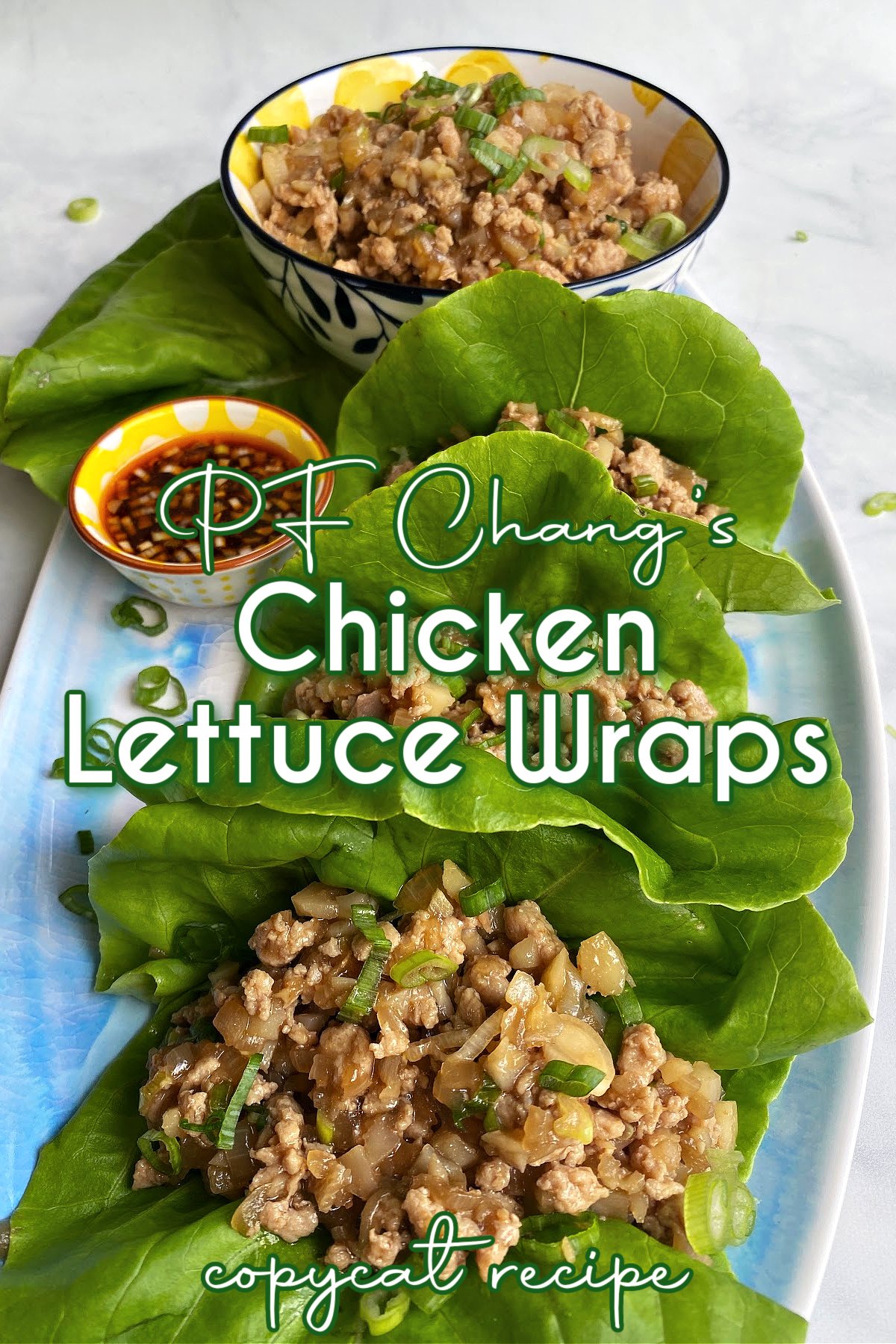 Chicken lettuce wraps on a long platter, with sauce and extra filling on the side. Pin text reads: PF Chang’s lettuce wraps copycat recipe.