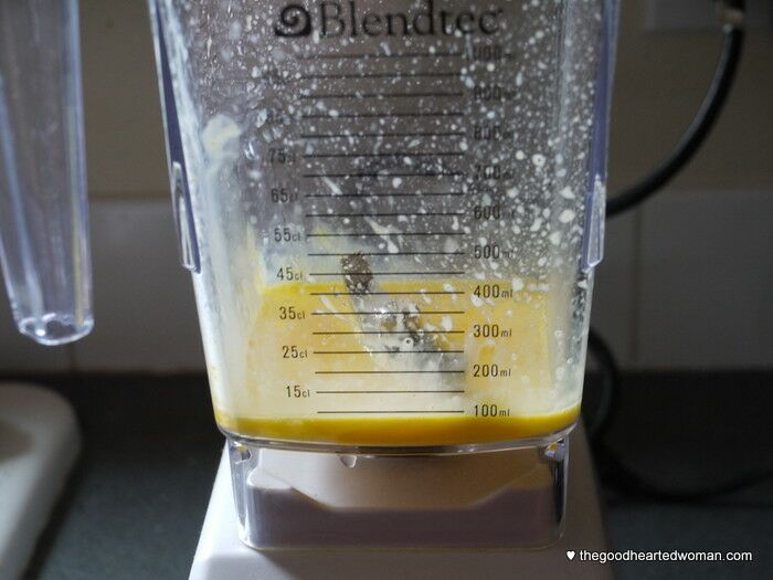 Side view of egg yolks blended in blender cup. 