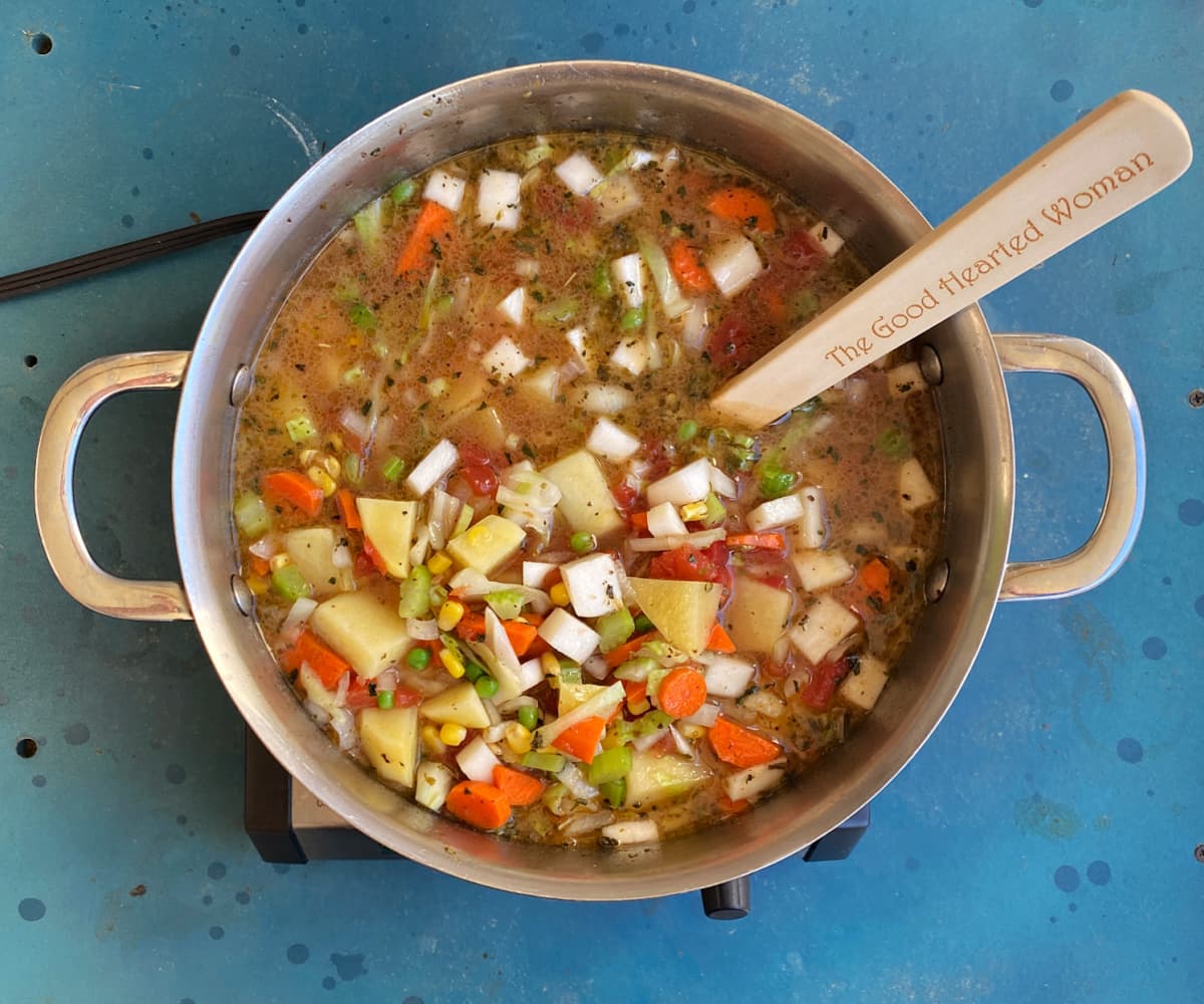 Vegetable soup before simmering, with vegetables added to beef stock.