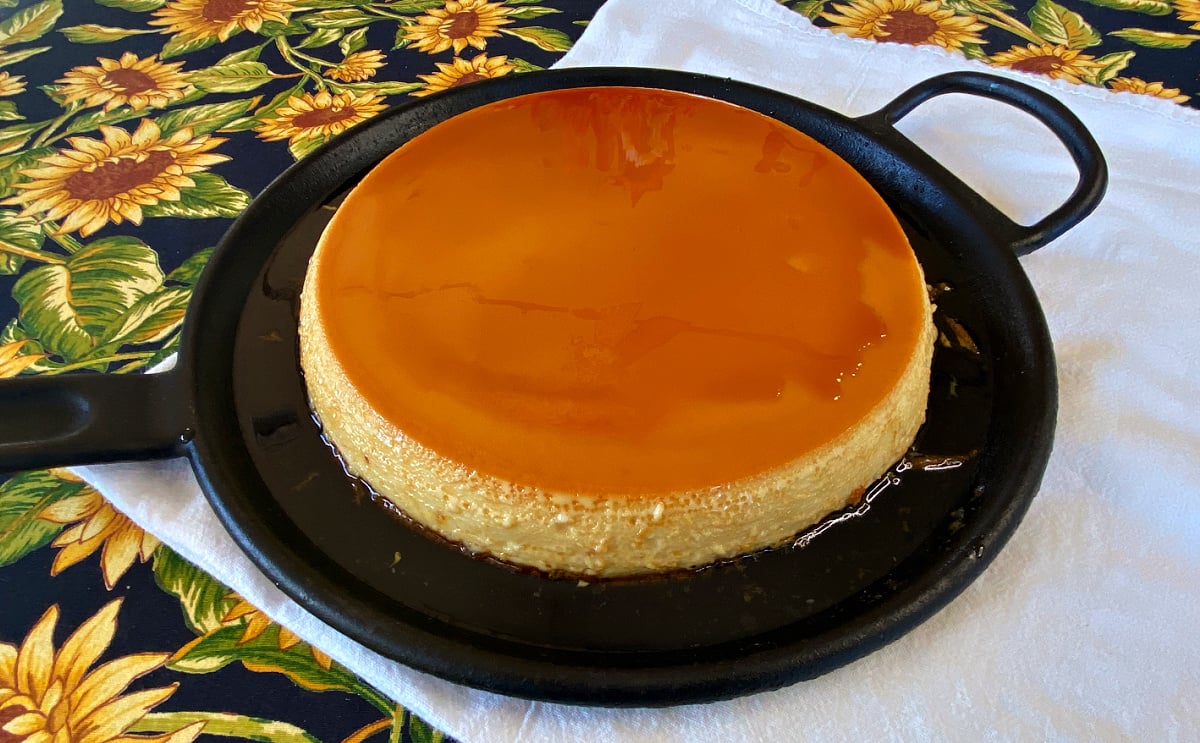 Large flan, whole, on a flat cast iron griddle. 