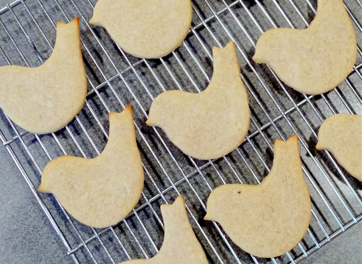 Bird-shaped shortbread cookies cooling on a wire rack.