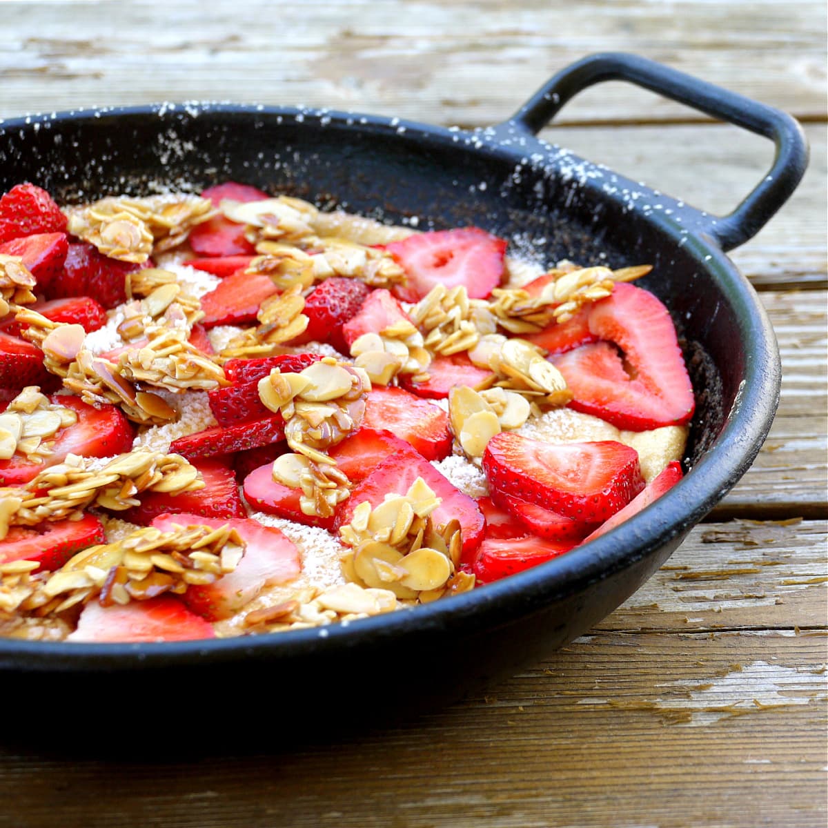 Strawberry covered omelet in cast iron skillet. 