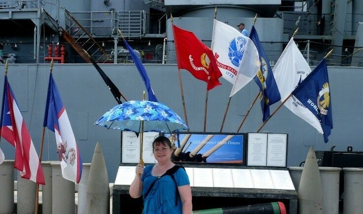 Me, in front of the USS Missouri, holding a tropical umbrella in the sun. 