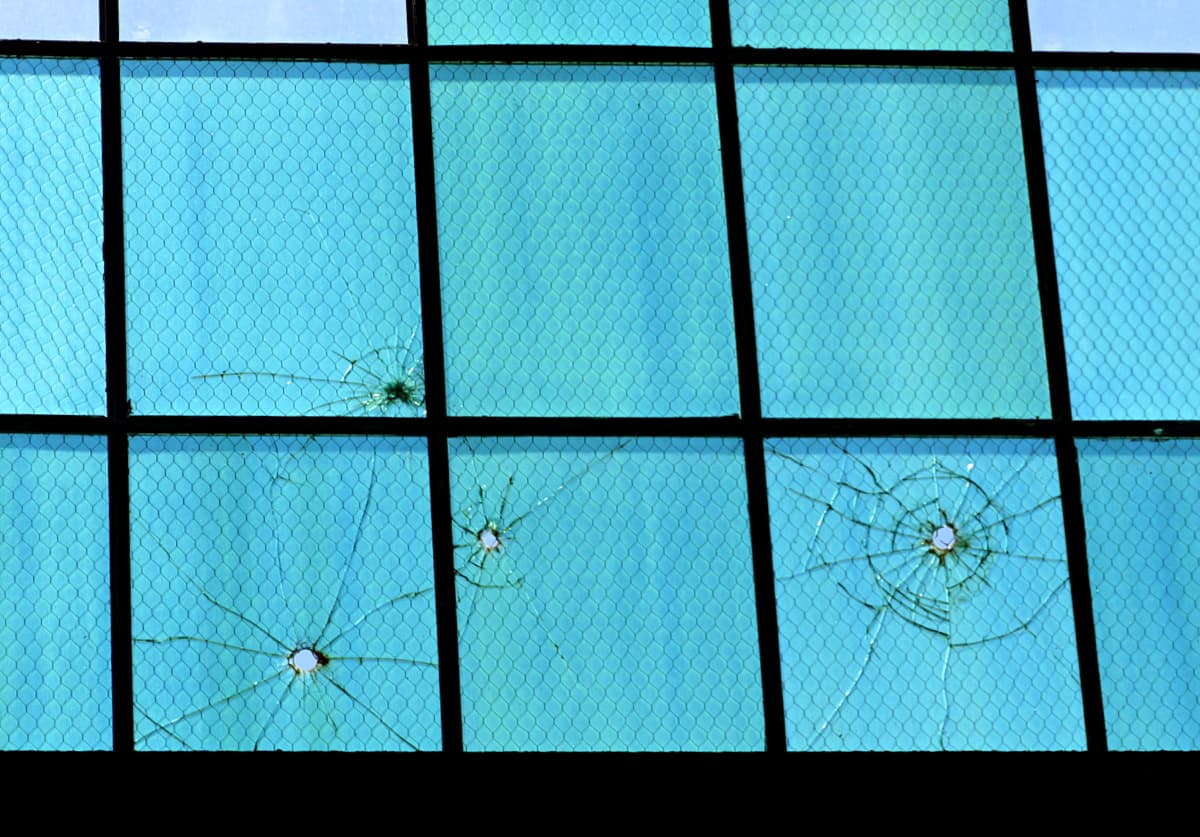 Bullet holes in Hanger 79 windows. 