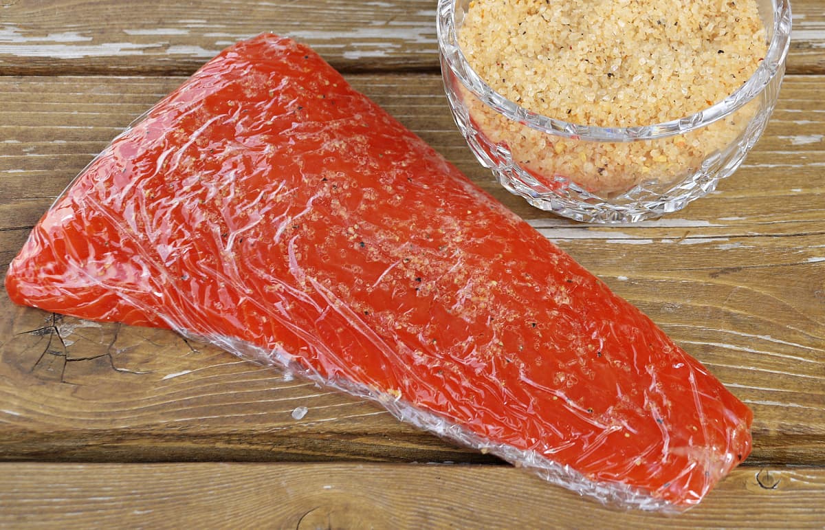 large fillet of Sockeye salmon wrapped in plastic.