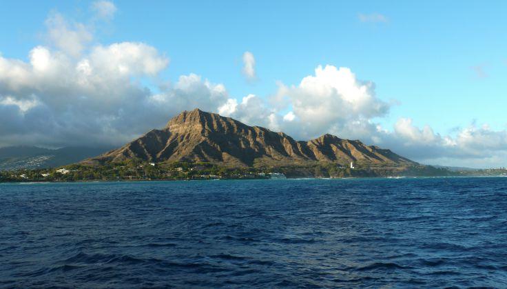 Long shot of Diamond Head taken from boat on water. 