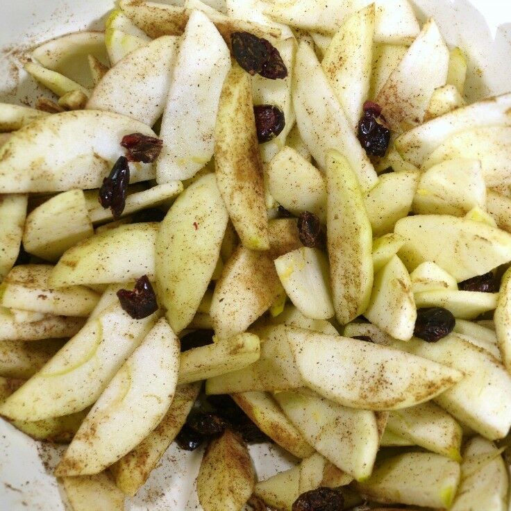 Sliced apples mixed with spices and Craisins. 