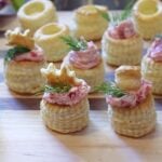 Smoked Salmon Pastry Cup Appetizers on a cutting board, garnished and ready to serve.