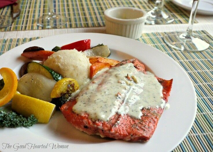 Baked steelhead fillet with mashed potatoes and sauteed squash on white plate. 