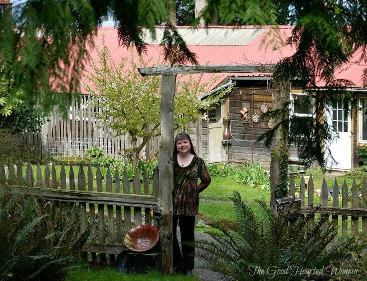 Middle-aged woman standing at the entrance to Orcas Island Pottery. 