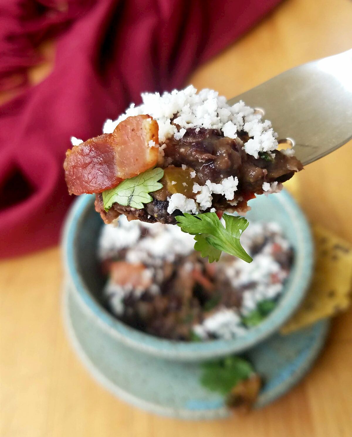bite of black beans with bacon
