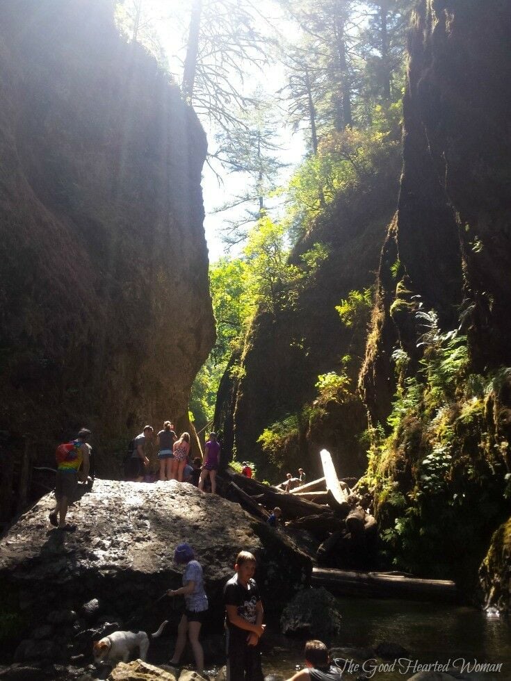 People standing on a large rock. 