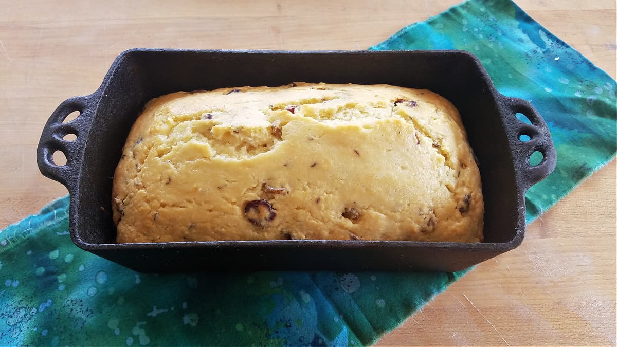 Loaf of quick bread baked in cast iron loaf pan.