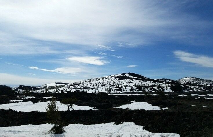 Landscape of snow on dark soil. Craters of the Moon National Monument & Preserve, Arco, Idaho