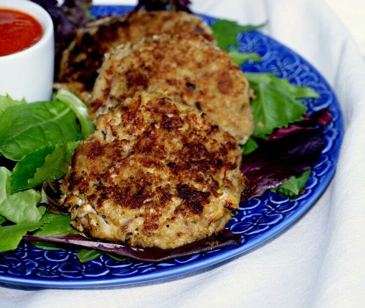 crab cakes on a blue plate. 