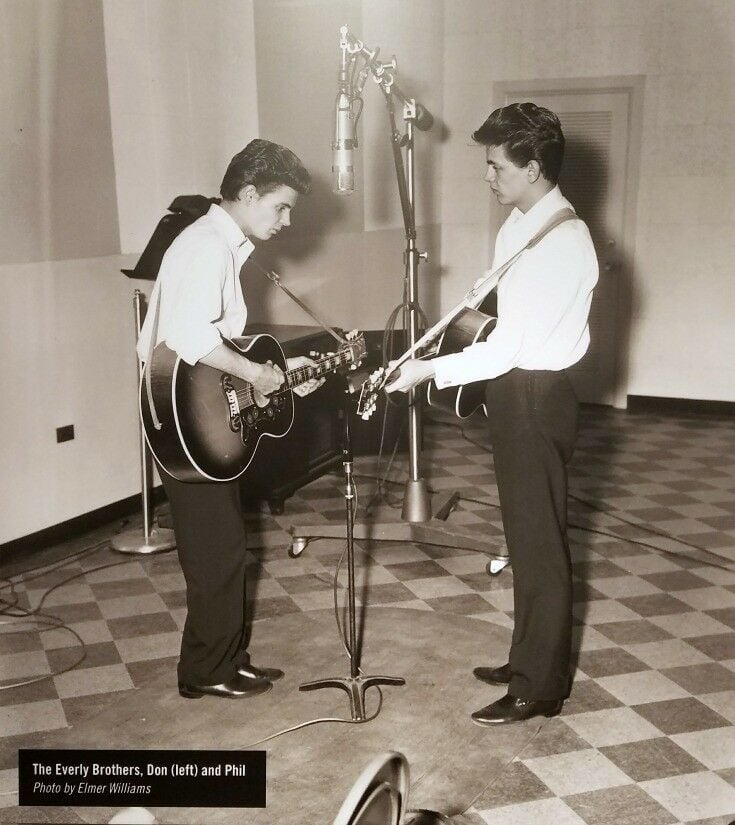 The Everly Brothers playing in the studio. 