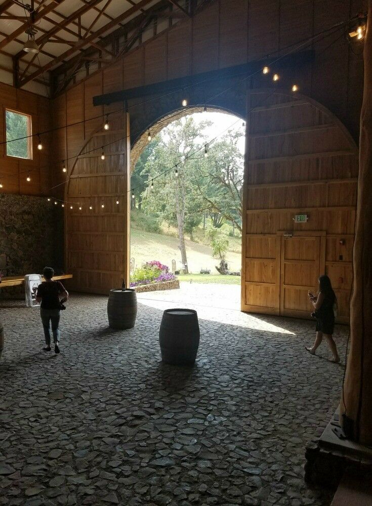 Expansive door slid open; sunlight illuminating stone floor.