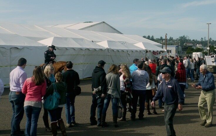 Crowd waiting outside the tents to be admitted. 