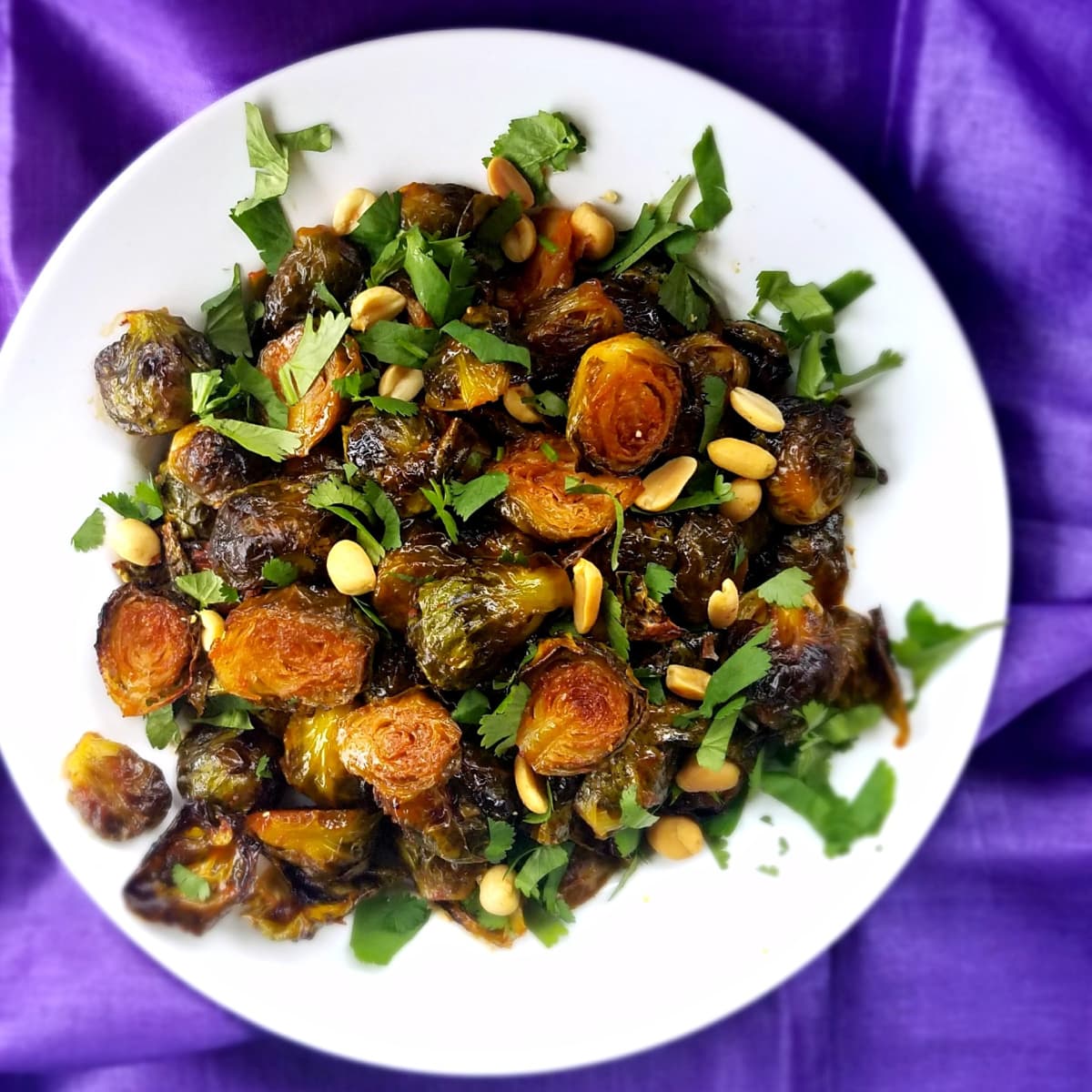 Gochujang Roasted Brussels, plated and garnished with peanuts and cilantro
