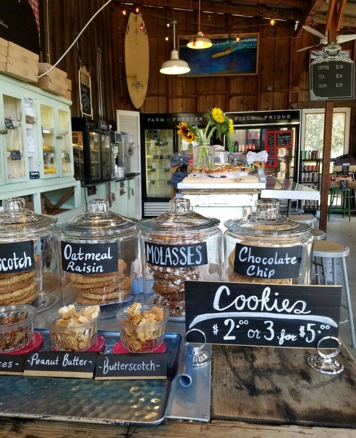 Interior of bakery shop, with labeled jars in foreground. 