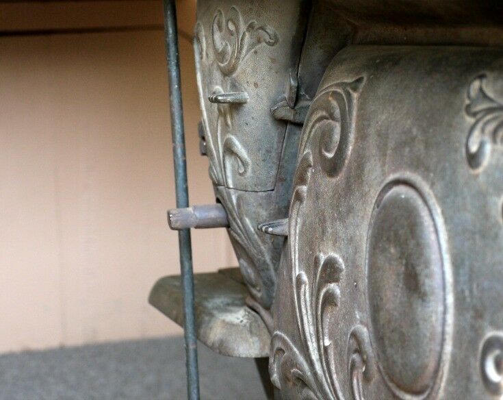 Close-up of ornamental detail on cast iron stove in Basque wagon. 