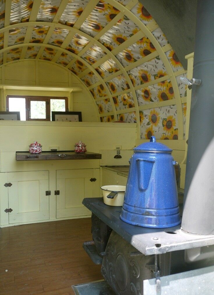 Interior of Basque wagon, with coffee pot, and sunflower wagon cover. 