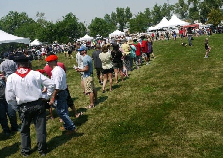 Line waiting in front of food tents. 