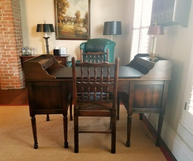 Old partner desk in room. 
