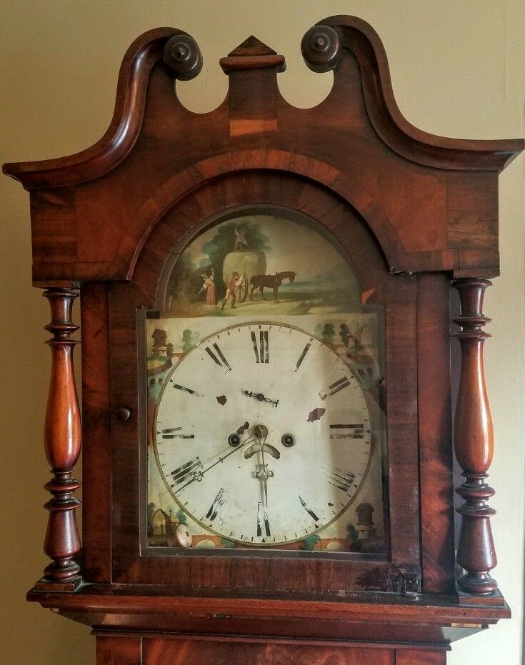 Clock face with painted carriage scenes. 